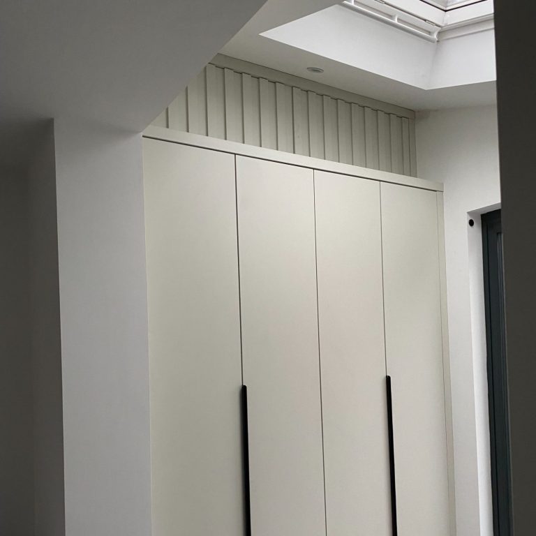 Modern interior with white cabinetry and skylight overhead.